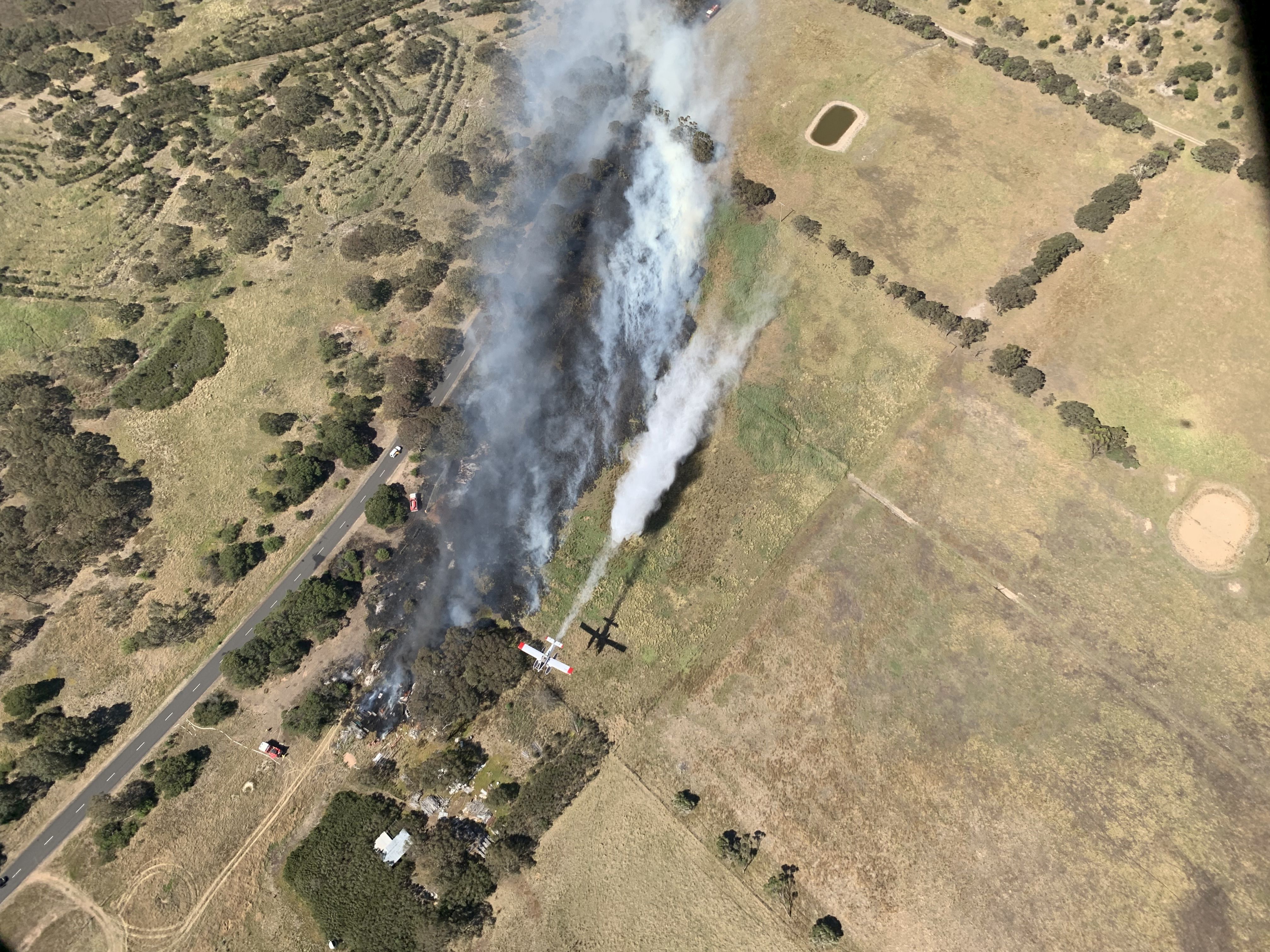 Ariel image of a small fire being put out in a dry field