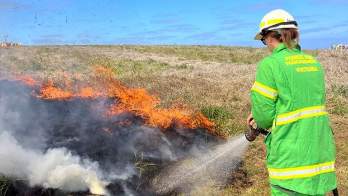 Ebony Stiles putting out grass fire 