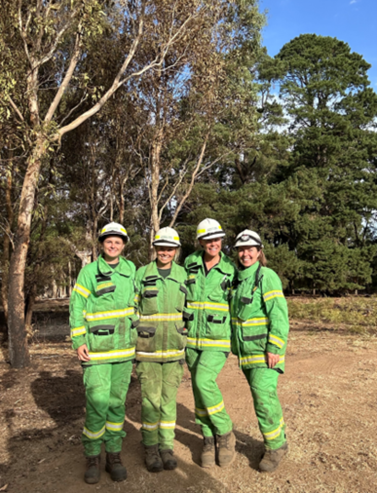 Ebony Stiles with crew members smiling outside in FFM uniform